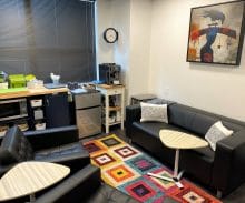 Academy Instructor lounge with coffee maker, microwave, refrigerator, and seating